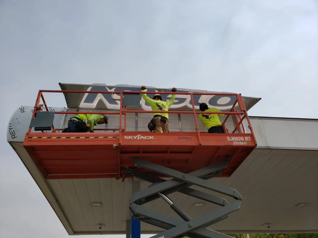 AA Sign Image installers working on a commercial signage project